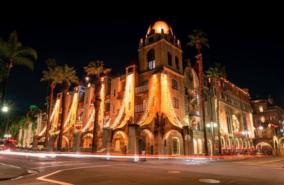 A stunning view of Mission Inn Riverside at night, beautifully illuminated with festive lights.
